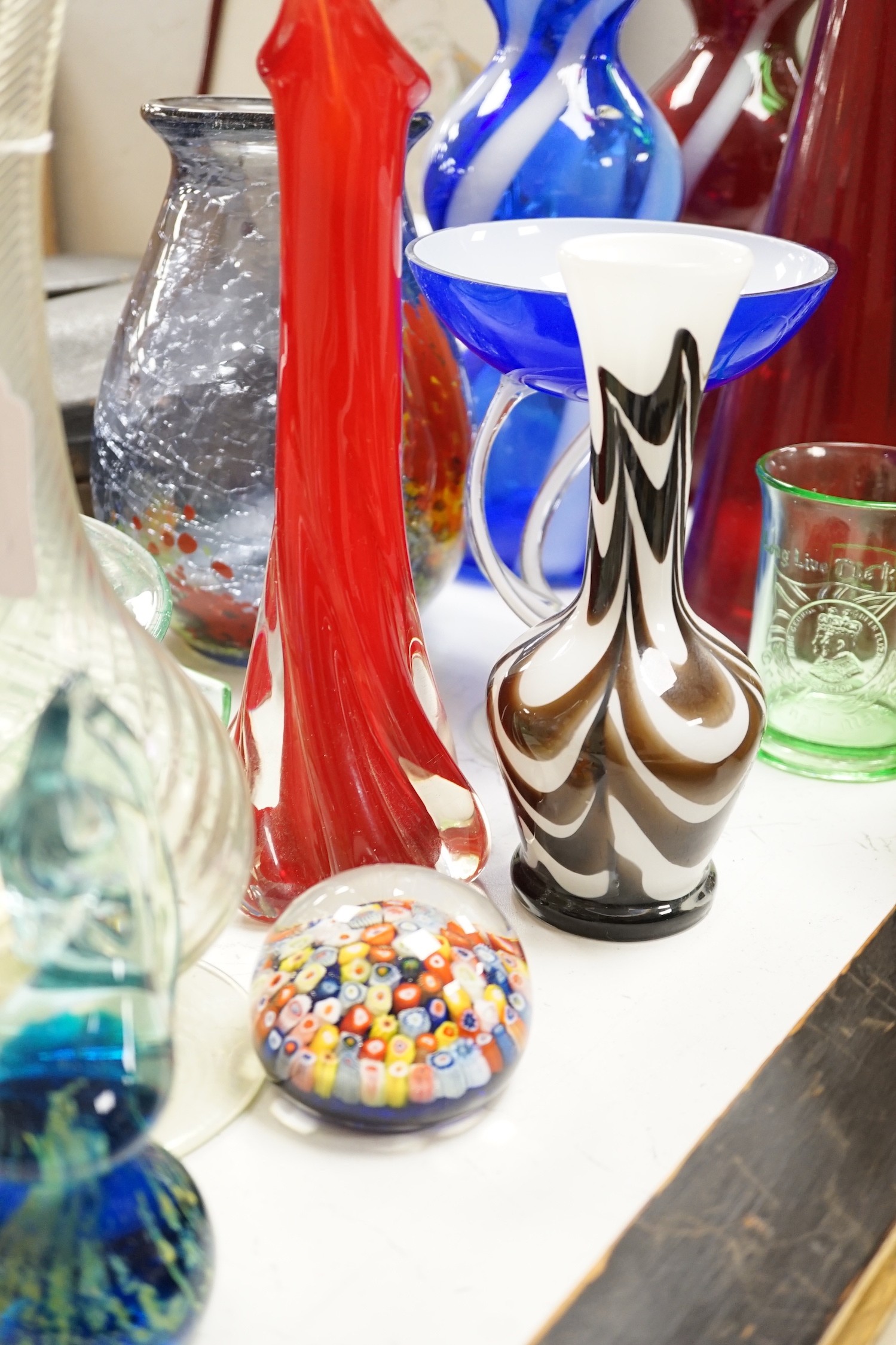 A large group of mixed art glass and other coloured glass vases, bowls, paperweights and two stoppered bottles etc, tallest 65cms high